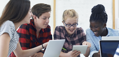 a group of students in classroom learning on tablets